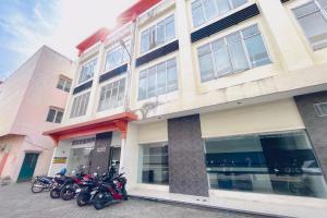 a group of motorcycles parked in front of a building at RedDoorz at STM Suite Medan Amplas in Medan