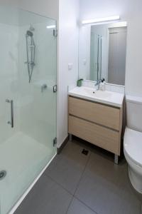 a bathroom with a sink and a shower and a toilet at Box Office on Madras in Christchurch