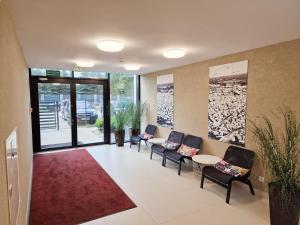 a waiting room with chairs and a red rug at Gęsi Puch in Gąski