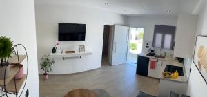 two views of a living room with a kitchen and a living room at PAME apartments in Kámpos