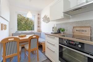a kitchen with a small table and a counter top at Fehmarnwelle in Niendorf