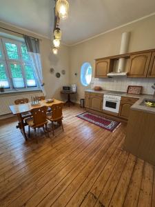 a kitchen with a table and a dining room at Landhausvilla Gut Vogelsang in Lalendorf