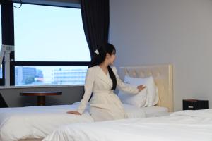 Postel nebo postele na pokoji v ubytování Hotel Wooin