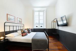 ein Schlafzimmer mit einem Bett und einem Fernseher darin in der Unterkunft Salotto Borbonico - Sanfelice in Neapel