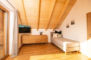 a bedroom with a bed and a wooden ceiling at Chalet Heimatzeit in Reichenbach +28 photos