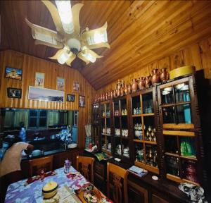 a bar with a table and a ceiling fan at Nawang Homestay By StayApart in Takdāh