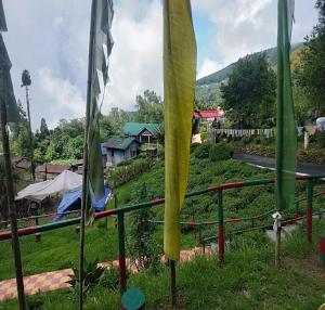 a group of flags hanging on a fence at Nawang Homestay By StayApart in Takdāh +4 photos