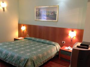 Un pat sau paturi într-o cameră la Hotel Desiderio