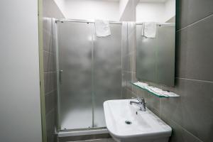 a bathroom with a shower and a sink and a mirror at Royal House Napoli Centro, by ClaPa Group in Naples