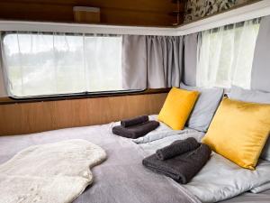 a bed in the back of a boat with yellow pillows at Majakatare Holiday Homes in Maasi