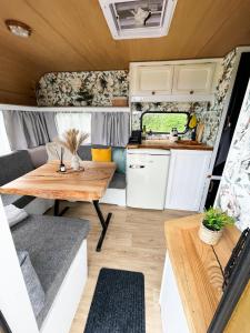 a kitchen and dining area of an rv with a wooden table at Majakatare Holiday Homes in Maasi