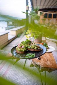a plate of food with a sandwich on a table at Room's at HAUS am SEE direkt am Thunersee gelegen mit SELF CHECK IN & digitaler Rezeption in Oberhofen am Thunersee