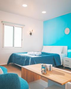 a bedroom with a bed and a table with chairs at Arka - Studio B in Anfah