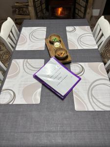 a table with a purple book on top of it at Lydie in Pressigny