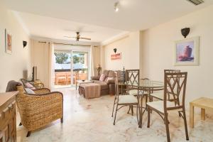 a living room with a table and chairs at Ibn Sadi in Nerja