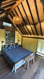a large bed in a room with a wooden floor at Lotus Forest Houses in Ngingas +25 photos