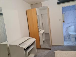 a bathroom with a mirror and a sink and a toilet at Room Four in Earley