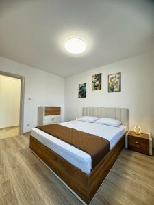 a bedroom with a large bed in a room at Cabacum Pleasure Beachfront Apartments in Varna City