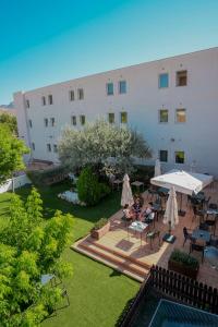 an image of a building with a courtyard with a pool at Hotel Caravaca Resort in Caravaca de la Cruz