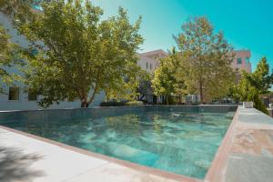 a swimming pool in a yard with trees at Hotel Caravaca Resort in Caravaca de la Cruz