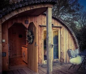 a large wooden house with a large door at Apple Tree Cabin in Mitchel Troy