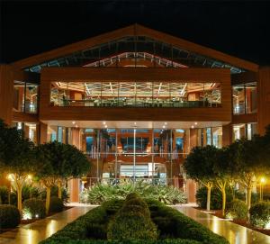 an external view of a building at night at Hilton Dalaman Sarigerme Resort & Golf in Dalaman