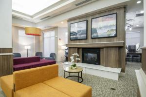a living room with a fireplace and a couch at Hilton Garden Inn Hattiesburg in Hattiesburg