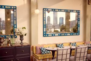a dining room with a couch and a table at Conrad New York Downtown in New York