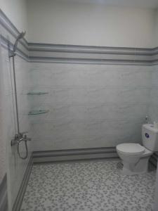 a bathroom with a toilet and a shower at Kim Long Hotel in Phan Thiet +16 photos