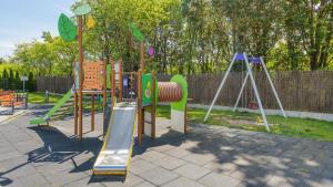 a playground with a slide and a swing at Słoneczna Dolina, Sun & Snow in Jastrzębia Góra