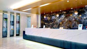 a lobby with a counter in a building at Hi-YES Hotel Hualien in Hualien City