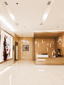 a large room with a large painting of a woman at Spacious studio MPLACE Tower C in Manila