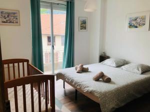 a bedroom with two beds and a large window at La casa de Soto in Lourdes