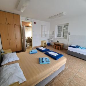 a bedroom with two beds with towels on it at Letovišče primarija Kurta Kanclerja Punat in Punat