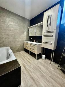 a bathroom with a sink and a white tub at Apartment with a great location in Weilheim in Weilheim in Oberbayern