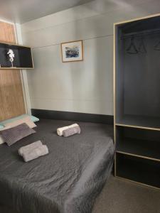 a bedroom with a bed with two towels on it at SUNNY Rest Nest in Pakoštane