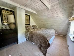 a bedroom with a bed and a wooden floor at Thatched country escape - Aarhus in Lystrup