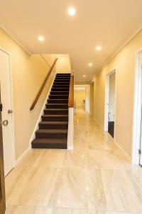 a hallway with a staircase in a house at Casa Del Aria - Contemporary, Luxe Linens in Truganina