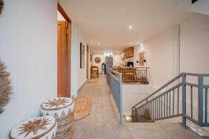 a hallway of a house with a staircase and a kitchen at Tropical Kasbah Ubud Central - Private Studio Rooms in Ubud +16 photos