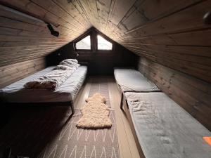 a group of beds in a room with a window at Hytte på Norefjell in Surteberg