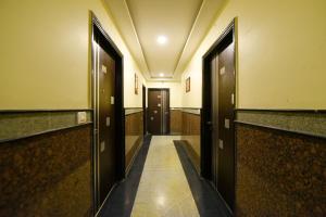 an empty hallway with two doors and a hallway with a hallway at Collection O Tip Top in Jaipur