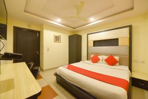 a hotel room with a bed with red pillows at Collection O Tip Top in Jaipur