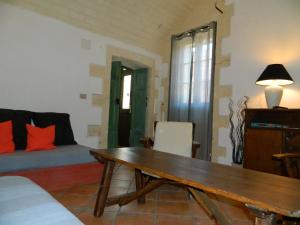 a living room with a wooden table and a couch at Michelino in Florinas