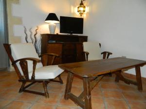 a dining room with a wooden table and chairs at Michelino in Florinas