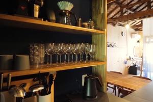 a row of glasses on a shelf in a kitchen at まちの別邸 緝 shu in Kochi