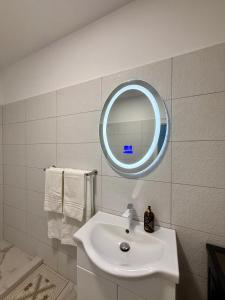 a bathroom with a white sink and a mirror at Apartament Lucas in Agigea +38 photos
