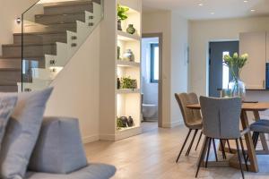 a dining room and living room with a table and chairs at Ampeli Villas in Stoupa