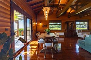 a dining room with a table and chairs at Villa PARADISE in Nea Michaniona