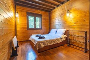a bedroom with a bed in a wooden cabin at Villa PARADISE in Néa Michanióna +85 photos