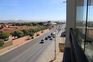 a view of a street with cars parked on the road at Hotel Melo in Montes Claros